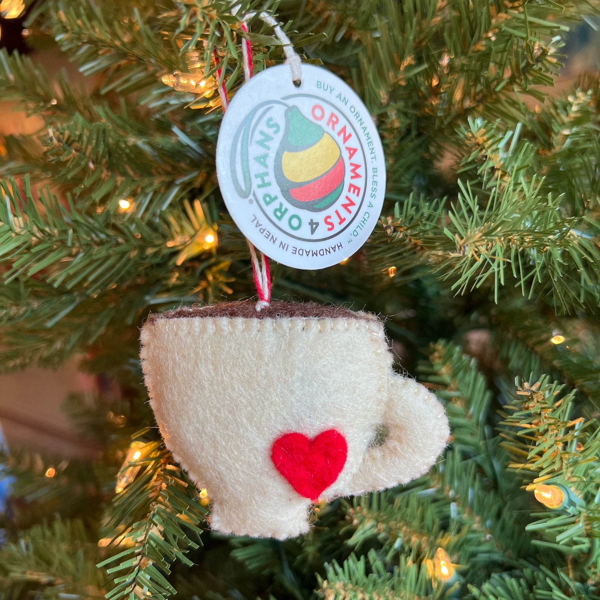 felt latte ornament hanging on a Christmas tree