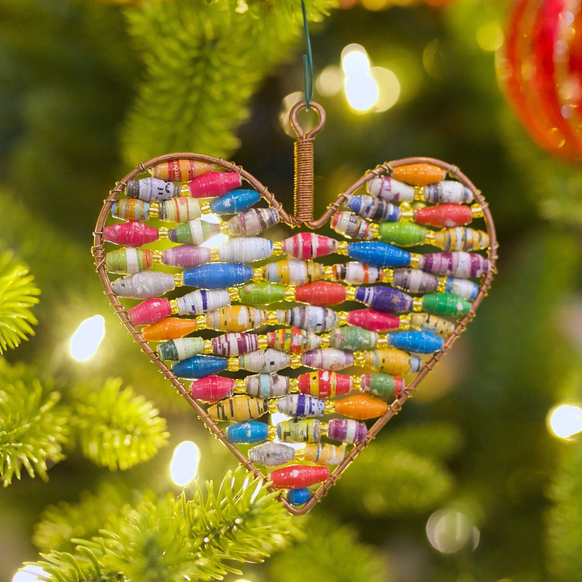 recycled paper bead heart ornament hanging on Christmas tree