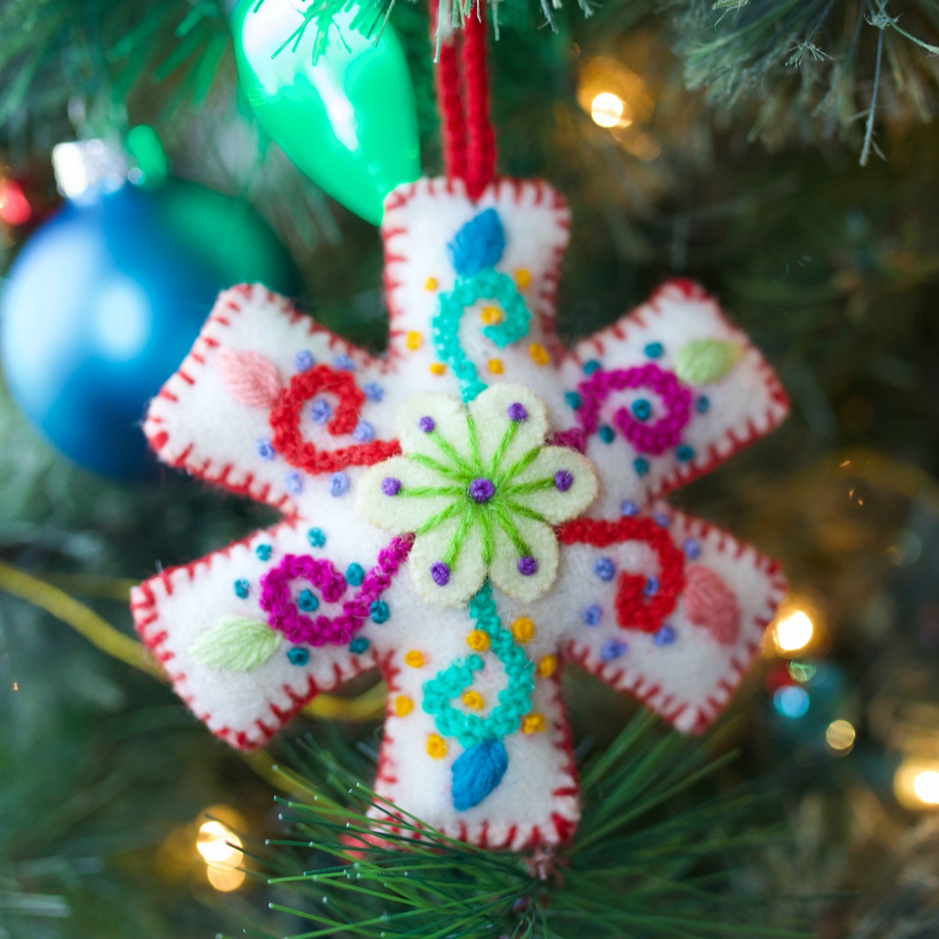 Red Embroidered Snowflake Ornament on Christmas Tree