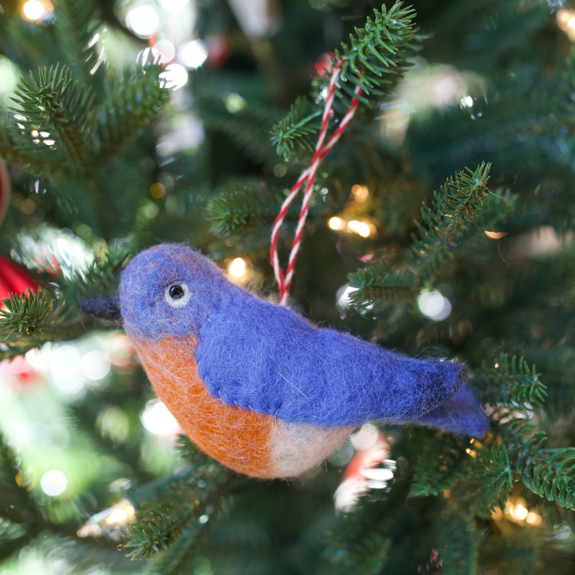 Blue Bird Ornament hanging on a Christmas tree