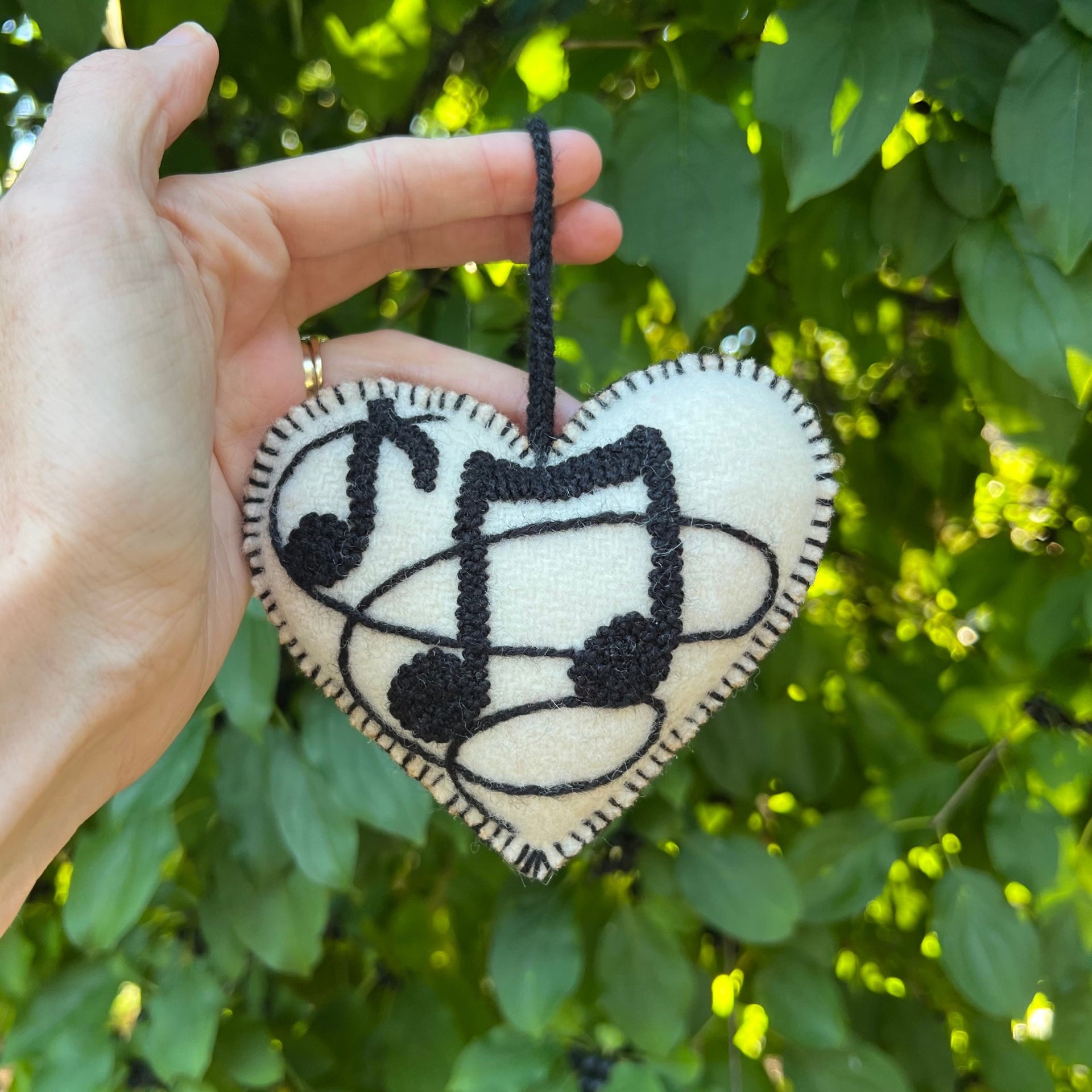 Musical Heart Christmas Ornament being held outside