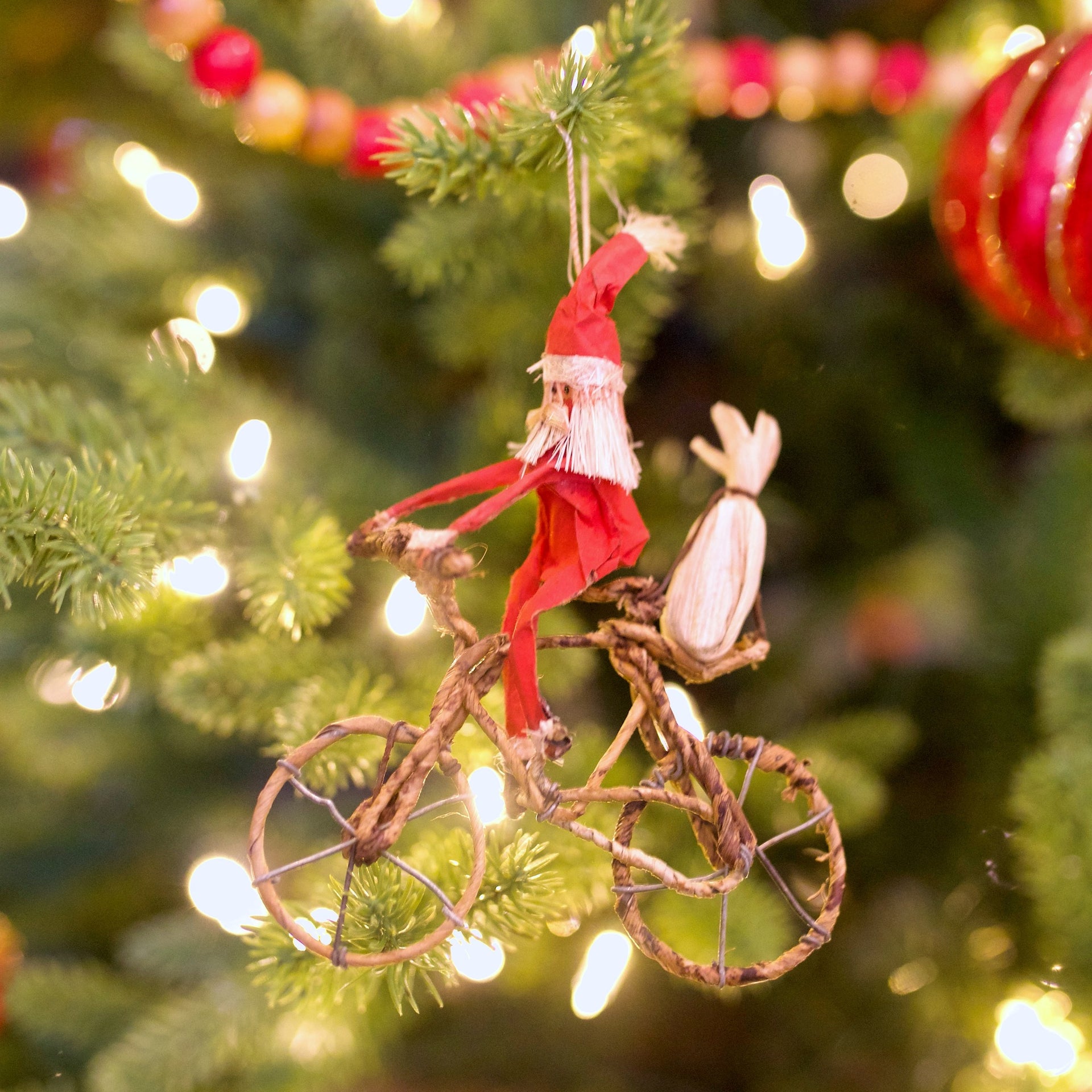 african Santa riding a bicycle ornament hanging on Ornaments 4 Orphans Christmas tree