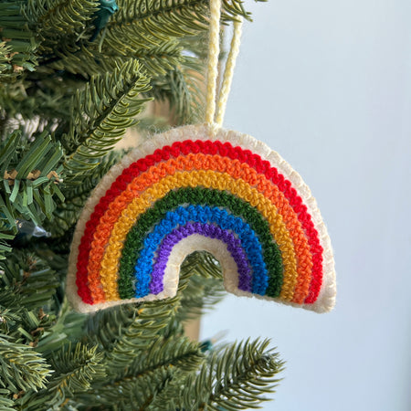 embroidered wool rainbow ornament hanging on Christmas tree