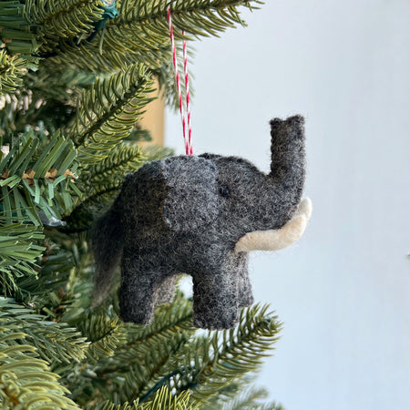 gray felt elephant ornament hanging on a christmas tree