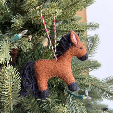 Horse-shaped ornament hanging on a Christmas tree