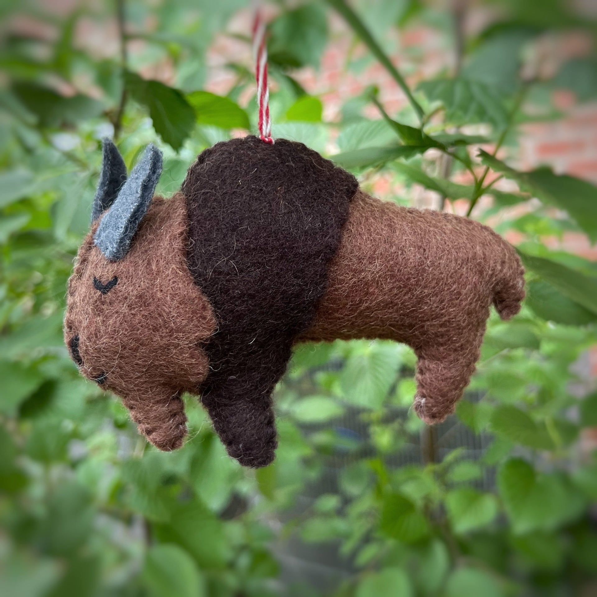 Sleeping buffalo bison christmas ornament hanging on a tree