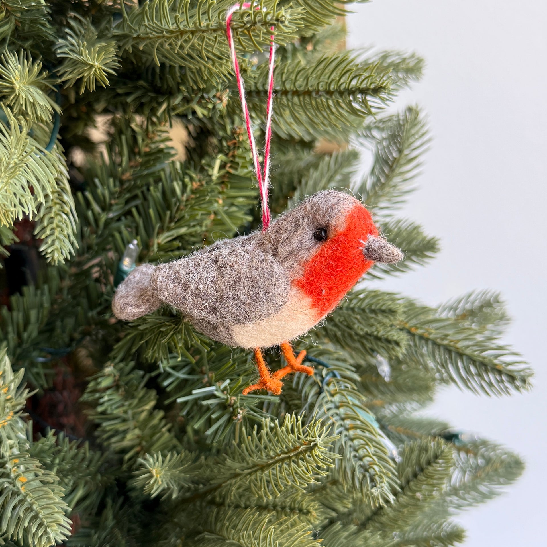 felt robin ornament hanging on a Christmas tree