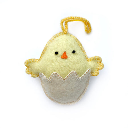 Handmade soft baby chick Easter ornament hatching from egg.