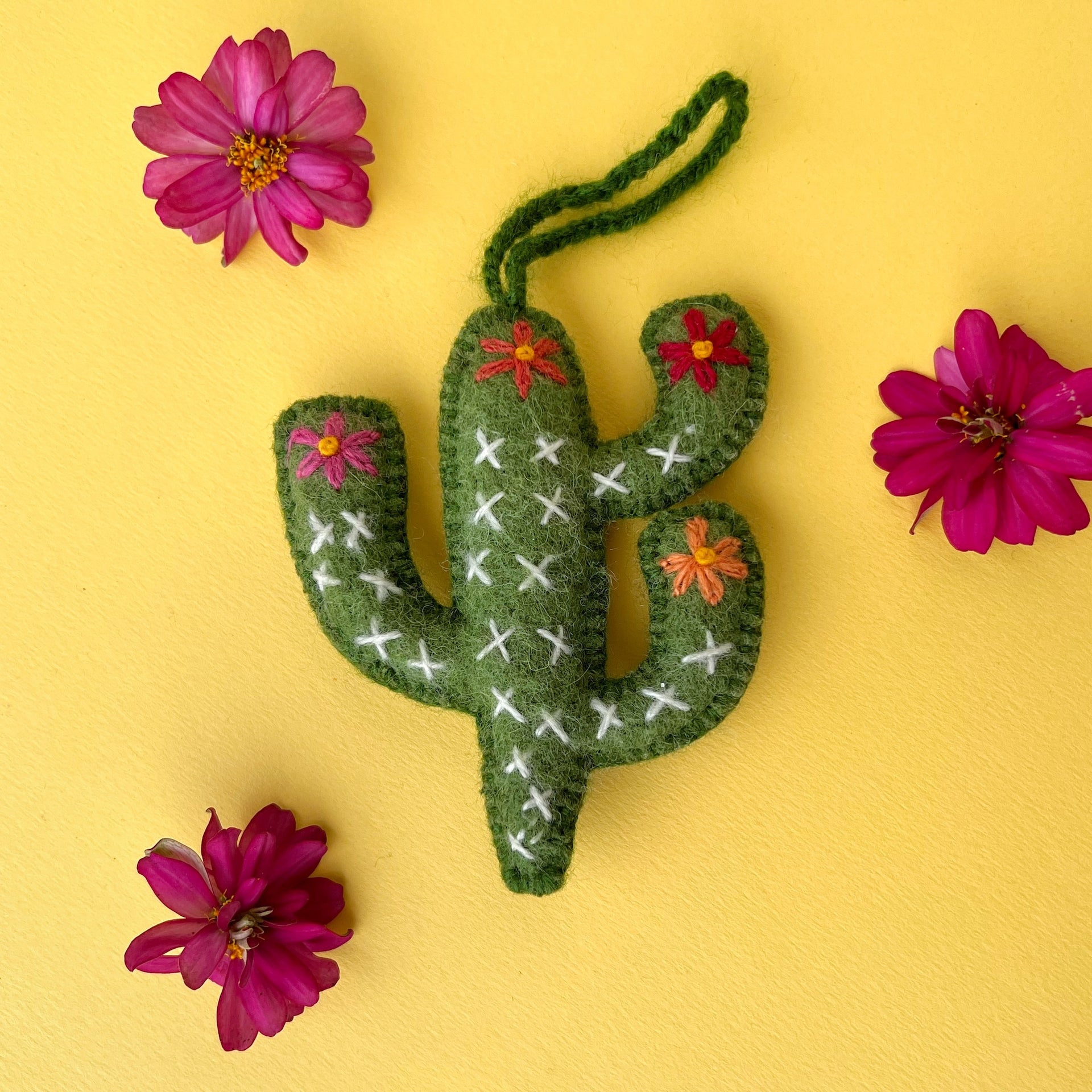 embroidered Cactus Christmas ornament styled on yellow with pink flowers