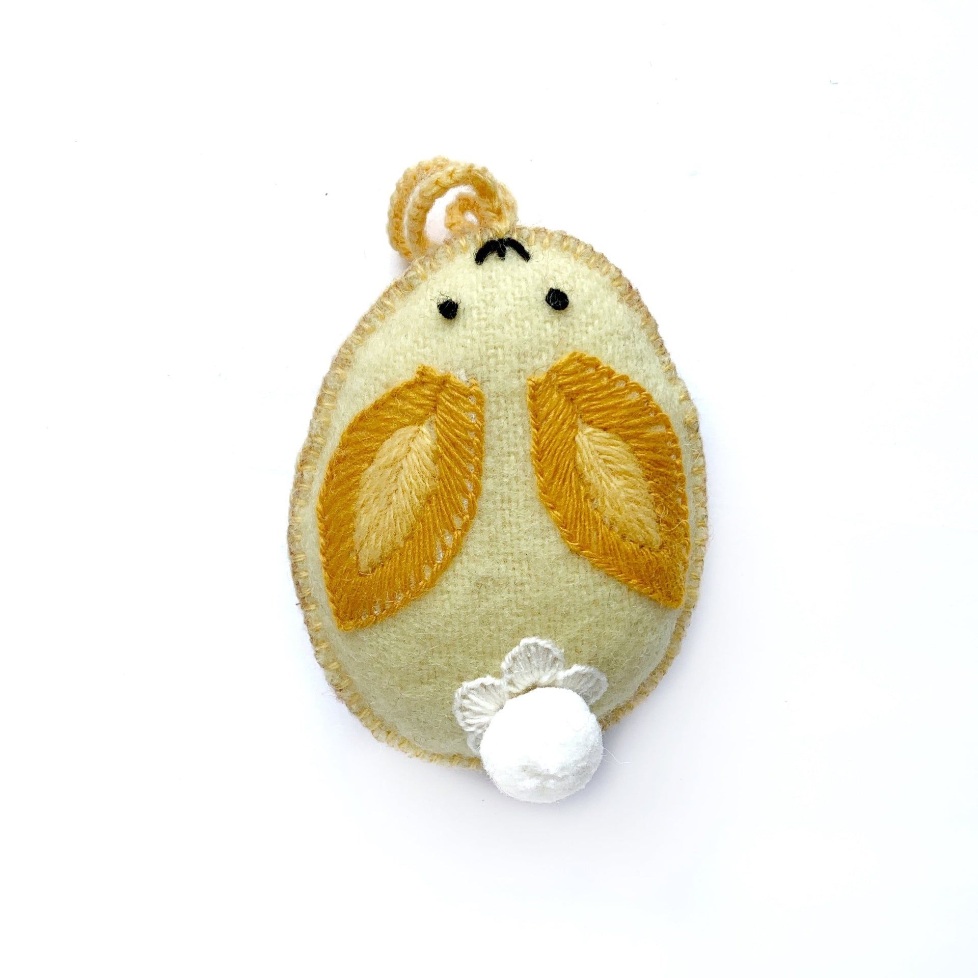 yellow bunny egg Easter ornament with pom pom tail.