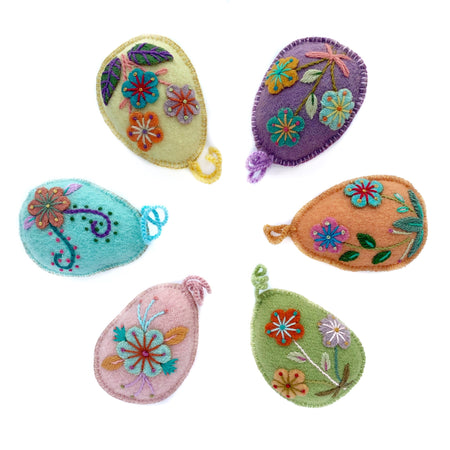 Set of six pastel Easter egg ornaments with hand embroidered flowers and designs.