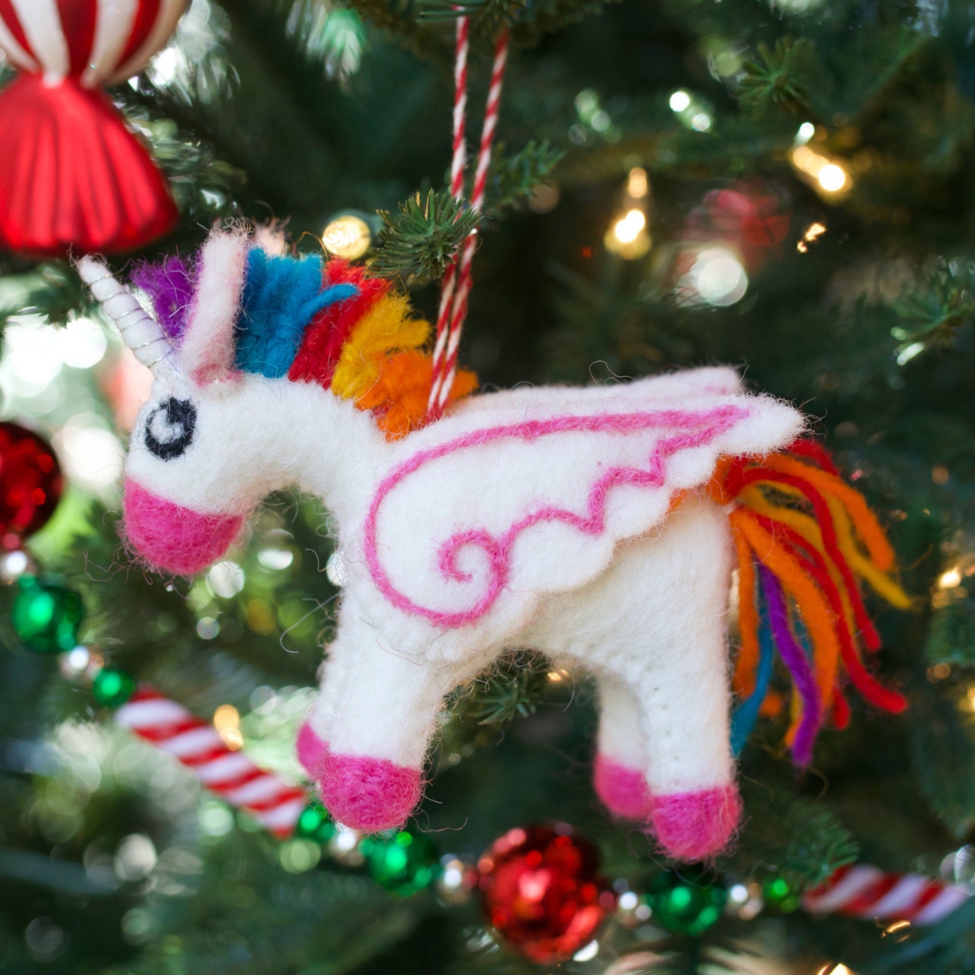 soft colorful Unicorn Ornament hanging on a Christmas Tree